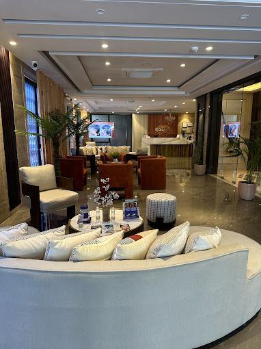 Waiting lounge with a curved sofa and warm wood wall