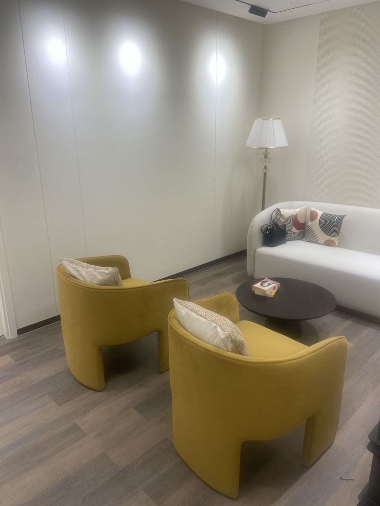 Quiet corner with ochre armchairs and a side table