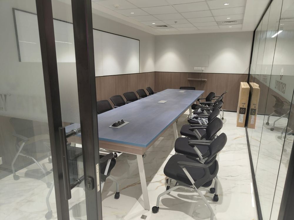 Glass-walled conference room with a long timber table